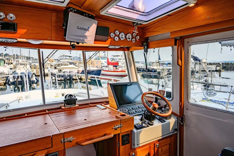  Yacht Photos Pics Interior of 2019 Targa 35 boat with wooden dashboard and marina view.