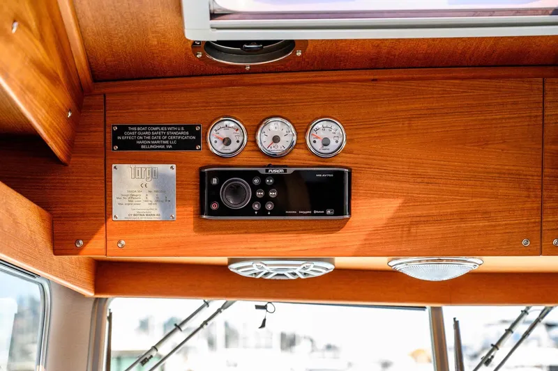  Yacht Photos Pics 2019 Targa 35 boat dashboard with gauges, control panel, and safety compliance plaque.