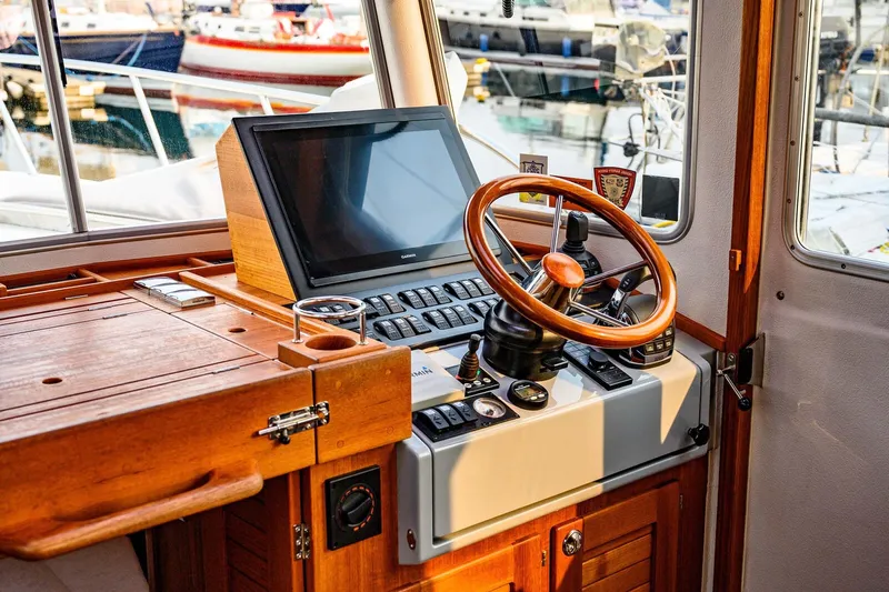  Yacht Photos Pics 2019 Targa 35 boat helm with wooden steering wheel and navigation equipment.