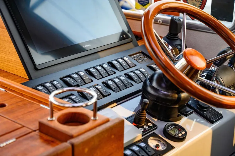  Yacht Photos Pics Control panel of a 2019 Targa 35 boat with wooden steering wheel and Garmin display.