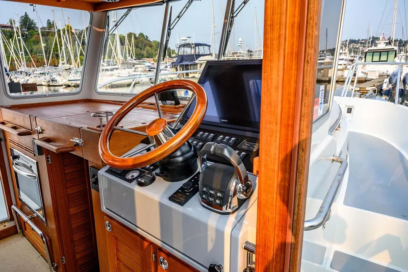  Yacht Photos Pics 2019 Targa 35 boat interior with wooden steering wheel and control panel at marina.