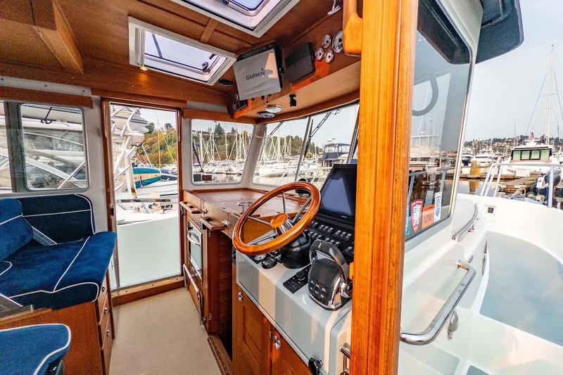  Yacht Photos Pics Interior of 2019 Targa 35 boat with wooden helm and modern navigation equipment.