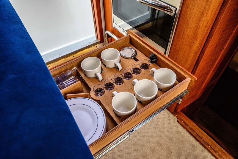  Yacht Photos Pics Wooden drawer with cups and glasses in a 2019 Targa 35 boat interior.