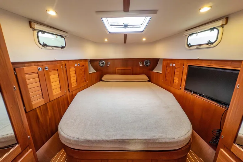  Yacht Photos Pics Cozy cabin interior of 2019 Targa 35 boat with wooden finish and comfortable bed.