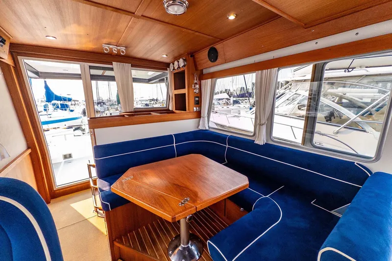  Yacht Photos Pics Interior of 2019 Targa 35 boat with blue seating and wooden table.