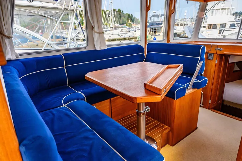  Yacht Photos Pics Interior of 2019 Targa 35 boat with blue seating and wooden table.