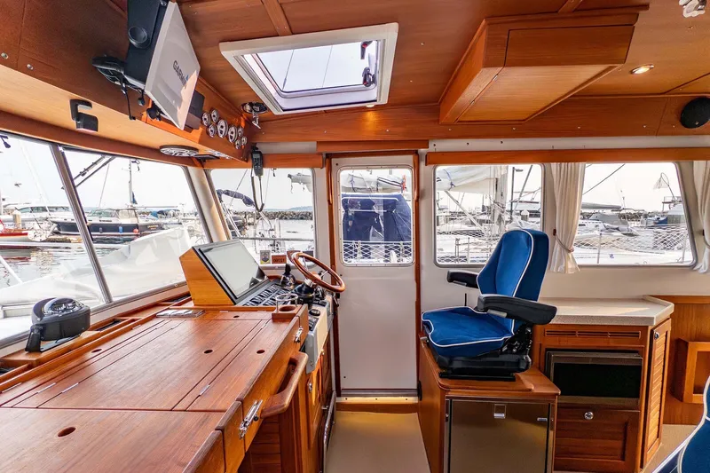  Yacht Photos Pics Interior of 2019 Targa 35 boat with wooden finish and blue captain's chair.