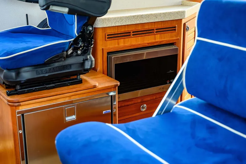  Yacht Photos Pics Interior of 2019 Targa 35 boat with blue seating and wooden cabinetry.