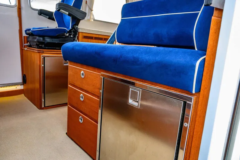  Yacht Photos Pics Interior of 2019 Targa 35 boat with blue seating and wooden cabinetry.