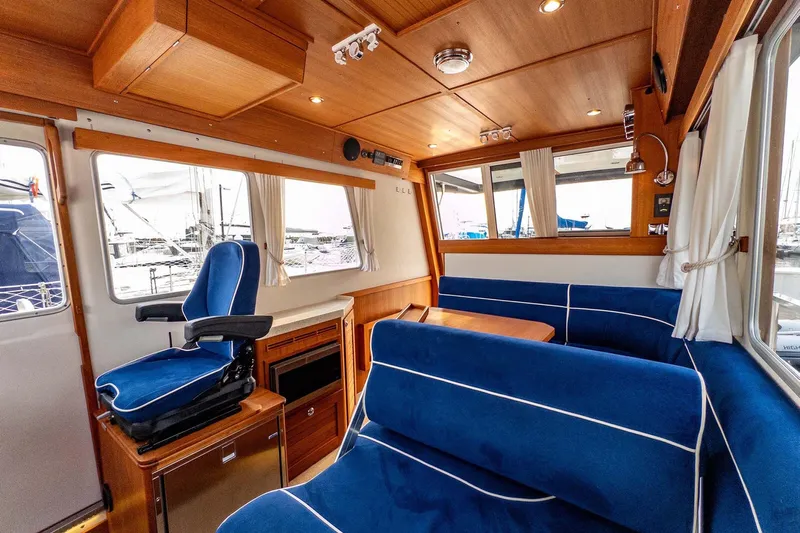  Yacht Photos Pics Luxurious 2019 Targa 35 yacht interior with blue seating and wooden accents.
