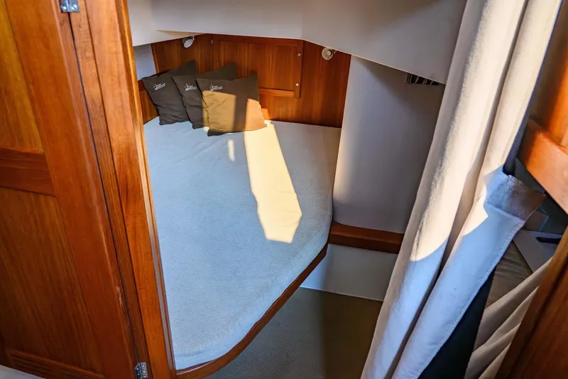  Yacht Photos Pics Cozy cabin interior of 2019 Targa 35 boat with wooden finish and cushions.