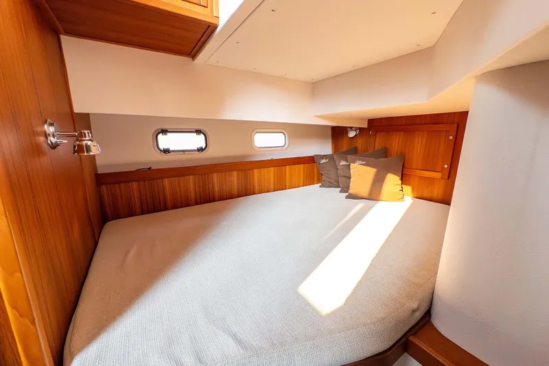  Yacht Photos Pics Cozy cabin interior of 2019 Targa 35 boat with wooden accents and soft lighting.