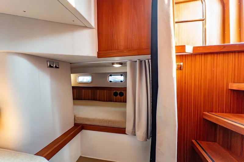  Yacht Photos Pics Cozy cabin interior of 2019 Targa 35 boat with wooden accents and small windows.