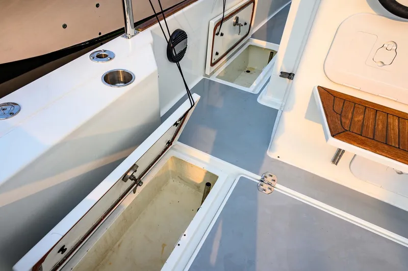  Yacht Photos Pics 2019 Targa 35 boat interior with open storage compartments and wooden seating.
