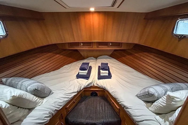 Kairos Yacht Photos Pics Cozy cabin interior of 2005 Selene 36 yacht with twin beds and wooden paneling.