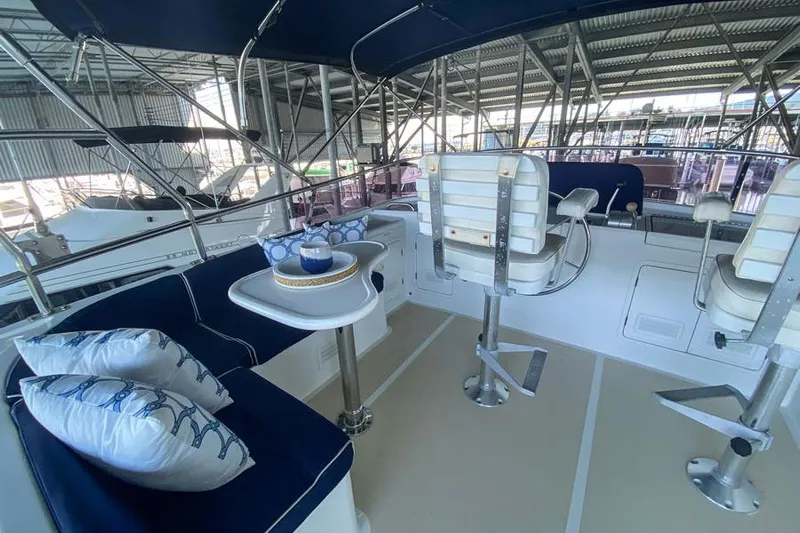 Kairos Yacht Photos Pics Interior of 2005 Selene 36 yacht with seating, table, and helm chairs.