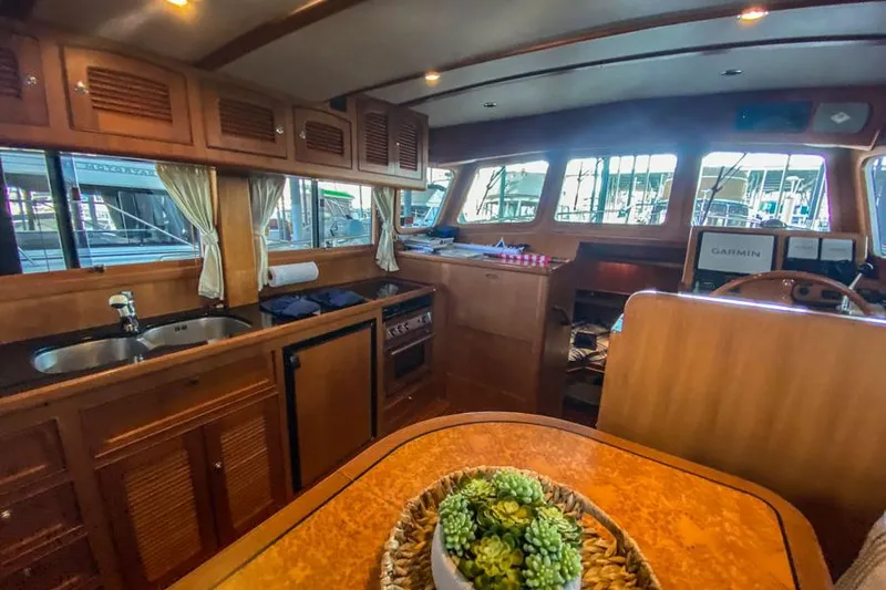 Kairos Yacht Photos Pics Interior of 2005 Selene 36 yacht with wooden cabinetry and kitchen area.