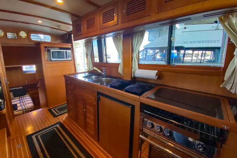 Kairos Yacht Photos Pics Luxurious 2005 Selene 36 yacht interior with wood finish and modern kitchen amenities.