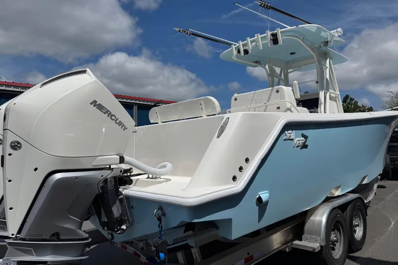  Yacht Photos Pics 2024 SeaVee 32Z boat with Mercury engine on trailer, under a cloudy sky.