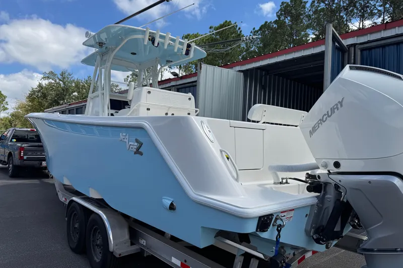  Yacht Photos Pics 2024 SeaVee 32Z boat with Mercury engine, light blue hull, parked on trailer.