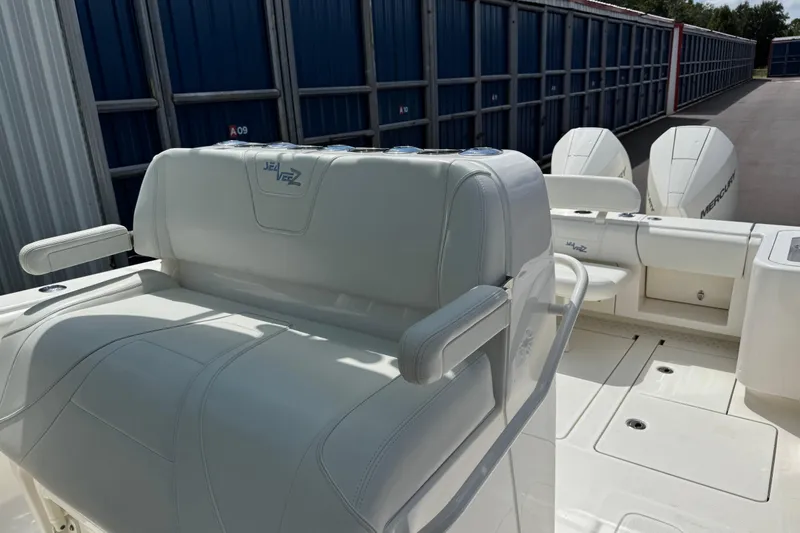  Yacht Photos Pics 2024 SeaVee 32Z boat interior with white seating and dual Mercury engines.