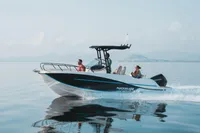 2026 Quicksilver 705 Open boat cruising on calm water with passengers onboard.