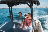 People enjoying a ride on a 2026 Quicksilver 705 Open boat in sunny waters.
