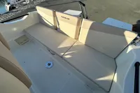 2026 Quicksilver 705 Open boat interior with beige seating and backrest.
