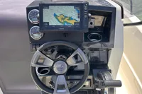 Quicksilver 705 Open 2026 boat dashboard with Garmin navigation system and steering wheel.