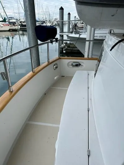 Kairos Yacht Photos Pics Selene 36 yacht deck, 2005 model, docked at marina with polished wood railing.