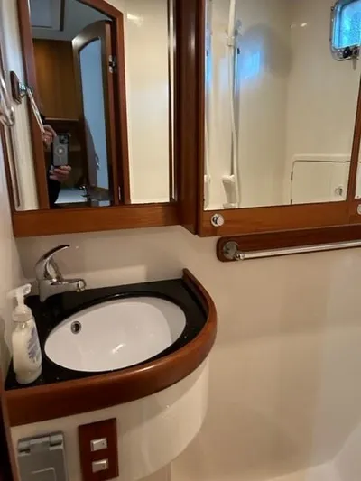 Kairos Yacht Photos Pics Bathroom interior of a 2005 Selene 36 yacht with sink and mirror.