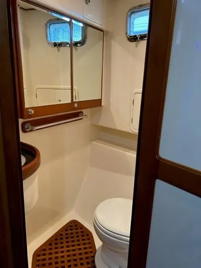Kairos Yacht Photos Pics Compact bathroom in 2005 Selene 36 yacht with wooden accents and mirrored cabinet.