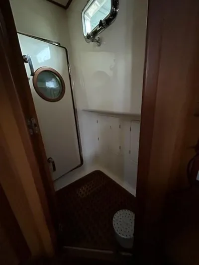 Kairos Yacht Photos Pics Interior of 2005 Selene 36 yacht bathroom with porthole and wooden flooring.