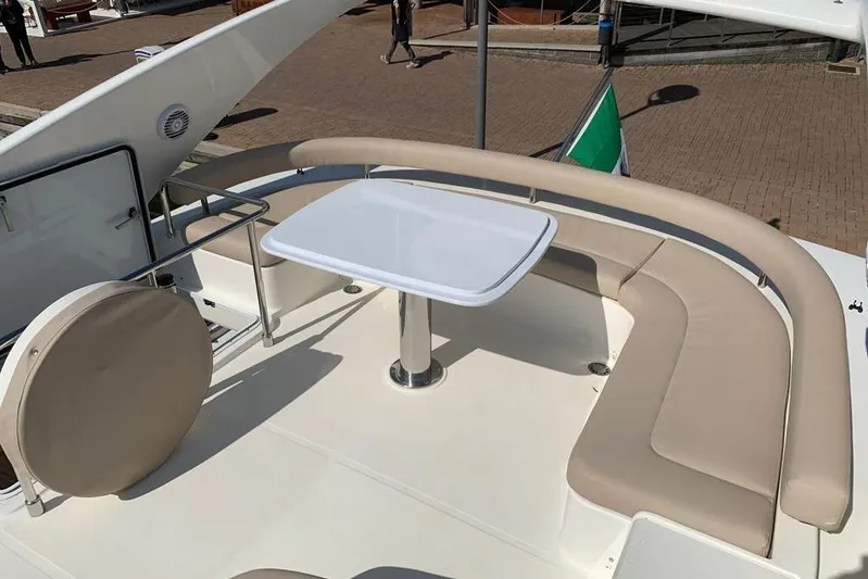  Yacht Photos Pics Luxurious seating area on 2004 Ferretti Yachts 620 with elegant table and cushions.