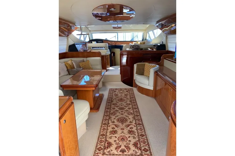 Yacht Photos Pics Luxurious interior of a 2004 Ferretti Yachts 620, featuring elegant wood finishes and plush seating.