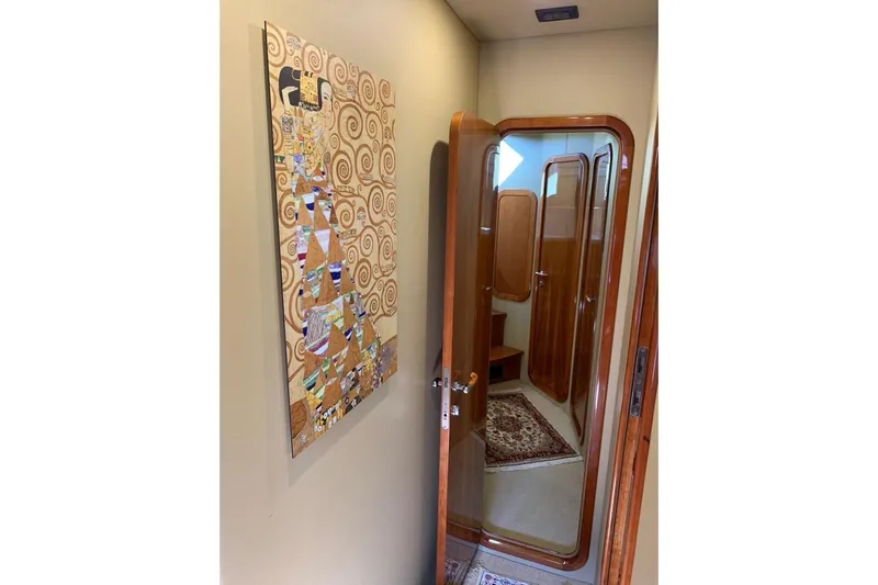  Yacht Photos Pics Interior of 2004 Ferretti Yachts 620 with wooden door and decorative wall art.