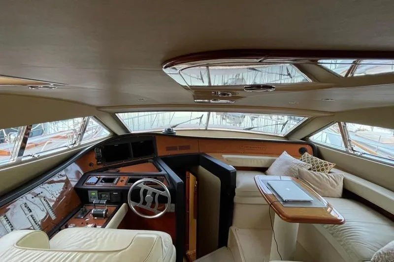  Yacht Photos Pics Luxurious interior of a 2004 Ferretti Yachts 620, featuring elegant seating and helm.