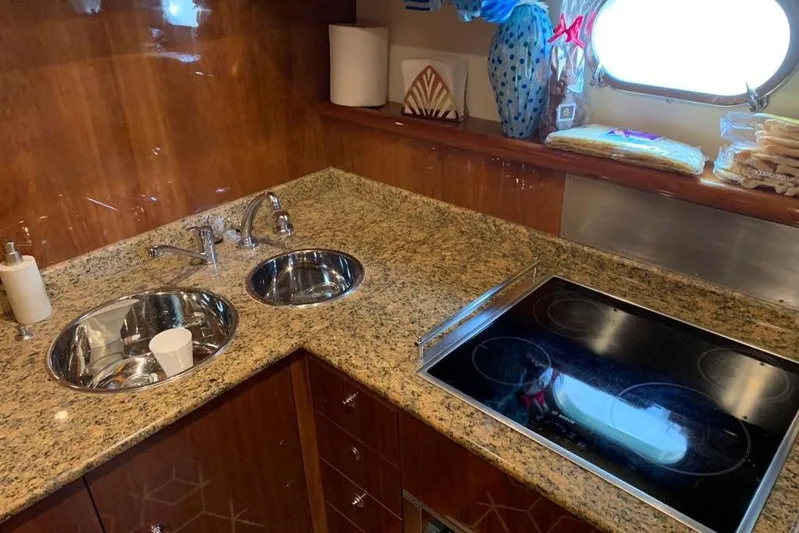  Yacht Photos Pics Luxurious kitchen in 2004 Ferretti Yachts 620 with granite countertops and modern appliances.