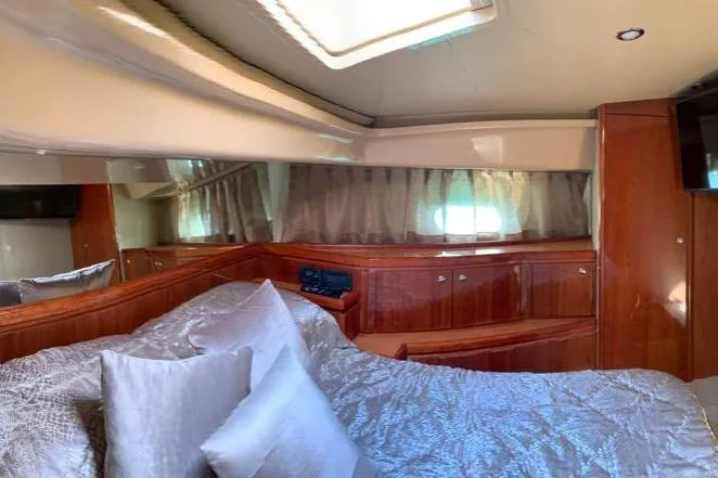  Yacht Photos Pics Luxurious bedroom interior of 2004 Ferretti Yachts 620 with elegant wood finish.