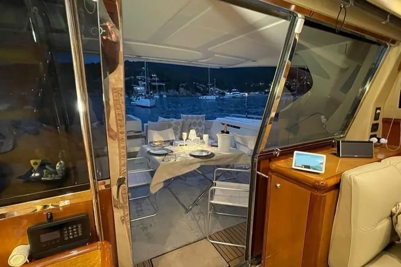  Yacht Photos Pics Luxurious 2004 Ferretti Yachts 620 interior with elegant dining setup and scenic marina view.