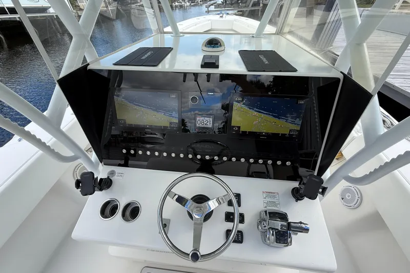  Yacht Photos Pics Steering console of a 2010 SeaHunter 40 boat with navigation screens and controls.