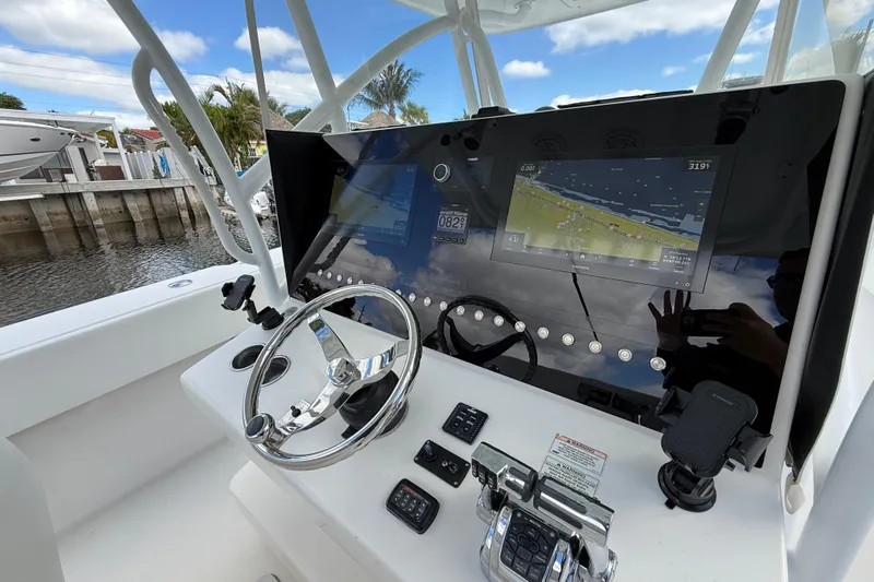  Yacht Photos Pics Steering console of 2010 SeaHunter 40 boat with navigation display and controls.