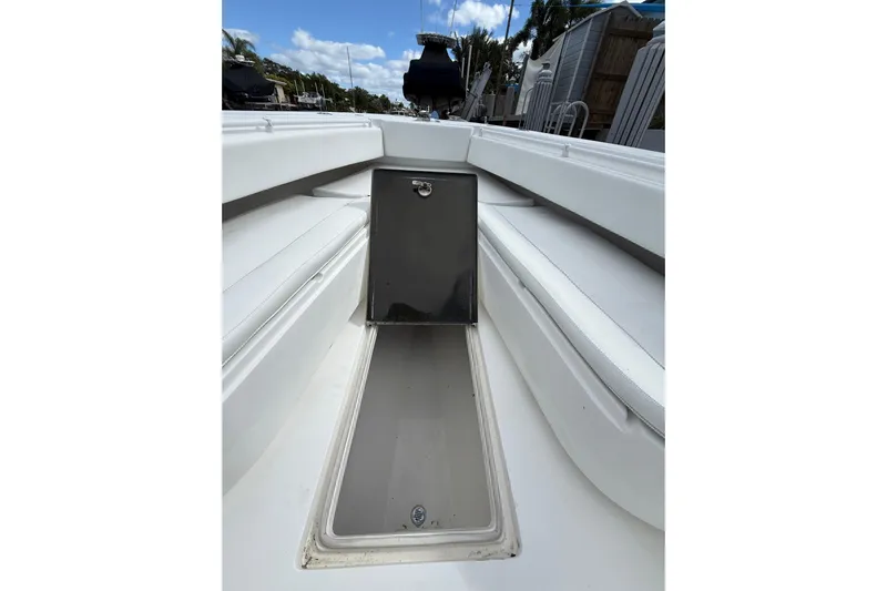  Yacht Photos Pics 2010 SeaHunter 40 boat interior with open storage compartment, white seating, and clear sky.