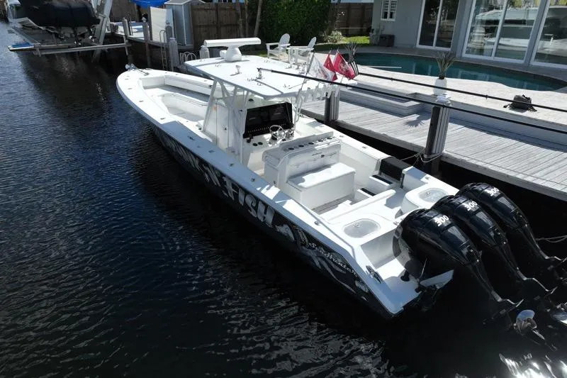  Yacht Photos Pics 2010 SeaHunter 40 boat docked, featuring triple outboard engines and spacious deck layout.