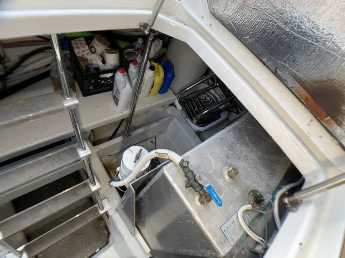 2006 56 Carver Voyager Yacht Photos Pics 2006 Carver 56 Voyager engine room with storage and maintenance supplies.