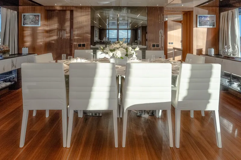 Neverland Yacht Photos Pics Luxurious dining area on 2020 Sanlorenzo 44 Alloy yacht with elegant white chairs.