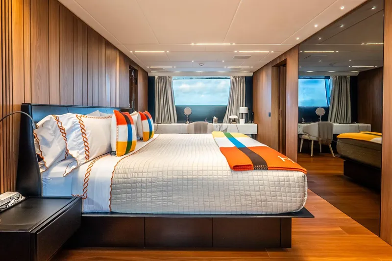 Neverland Yacht Photos Pics Luxurious bedroom interior on 2020 Sanlorenzo 44 Alloy yacht, featuring modern design and vibrant accents.