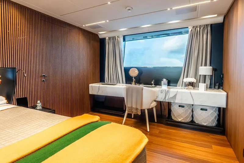 Neverland Yacht Photos Pics Luxurious Sanlorenzo 44 Alloy 2020 yacht bedroom with elegant wood paneling and marble desk.
