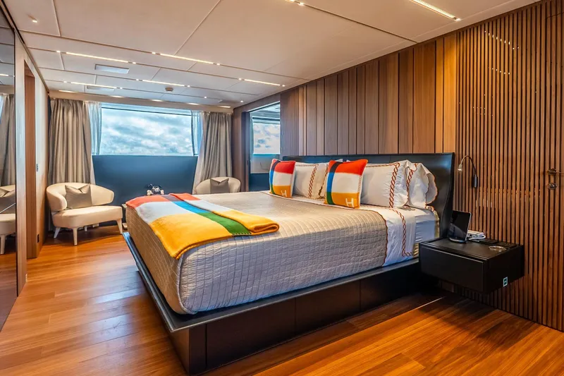 Neverland Yacht Photos Pics Luxurious bedroom interior on 2020 Sanlorenzo 44 Alloy yacht with modern design and wood accents.