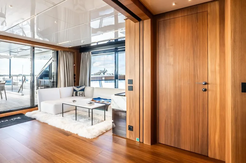 Neverland Yacht Photos Pics Luxurious interior of 2020 Sanlorenzo 44 Alloy yacht with modern wood paneling and elegant seating.